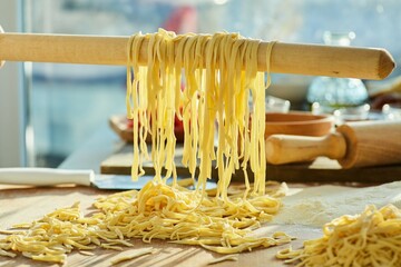 Step-by-step cooking process. We hang ready-made homemade noodles or pasta on a wooden rolling pin.