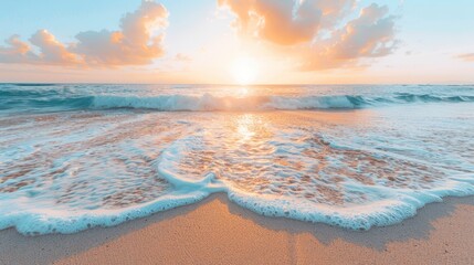 The sun is setting over the ocean waves, casting a warm glow on the beach with white sand