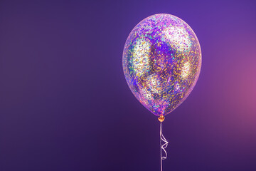 Wall Mural - A single balloon filled with iridescent glitter, catching the light and shimmering against a deep purple background.