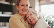 © peopleimages.com - Hug, portrait and mature mother with daughter together for bonding, relationship and love. Happy family, home and senior mom with woman in living room for embrace, affection and relax on weekend