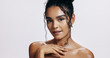 © peopleimages.com - Studio, shine and portrait of woman, confident and treatment of skincare, soft and glow body in results. White background, aesthetic and proud for skin, dermatology and cosmetics of person and hand