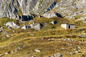 Wall Mural - Alpine landscape at hiking trail at Swiss mountain pass Gotthard with small stone barn on a sunny late summer day. Photo taken September 10th, 2023, Gotthard, Switzerland.