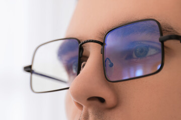 Canvas Print - Man wearing glasses on light background, closeup