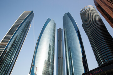 Wall Mural - Shot of towering city skyscrapers clustered together in the evening