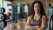 © gn8 - Confident Middle Aged Hispanic Female Fitness Trainer in Gym Environment, Promoting Healthy Lifestyle and Strength Training