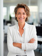 © Enrique - european businesswoman in his late fifties wearing a white suit and white shirt, office background
