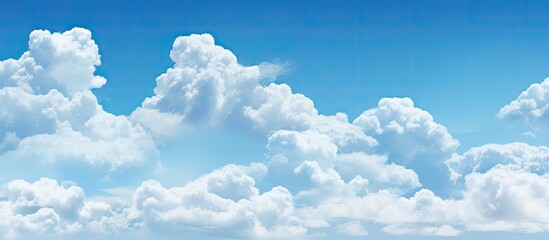 Aufkleber - Fluffy white clouds floating in a clear blue sky providing ample empty space for an image
