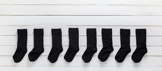 Aufkleber - Pair blank black small low socks flat lay on white wood board side view mock up for design print presentation advertising top view copy space