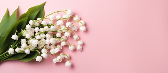 Poster - Copy space image of a top view bouquet of lilies of the valley on a pink background creating a floral setting that is perfect for occasions like Mother s Day or Women s Day