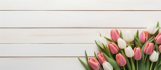 Aufkleber - Copy space image of a laptop placed on a white floor surrounded by beautiful tulips