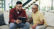 © peopleimages.com - Tablet, teaching and man with senior father on sofa helping with communication, internet or email. Happy, bonding and elderly male person learning digital technology with son in living room at home.