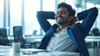 © LukaszDesign - A young mixed-race businessman stretching and resting with his hands behind his head in an office. Confident Hispanic entrepreneur relieved after meeting deadlines