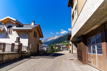 Wall Mural - Scenic view of alley at Swiss mountain village Airolo on a sunny late summer noon. Photo taken September 10th, 2023, Airolo, Canton Ticino, Switzerland.