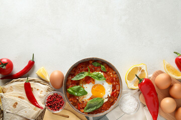 Wall Mural - Shakshuka in a bowl on a light background