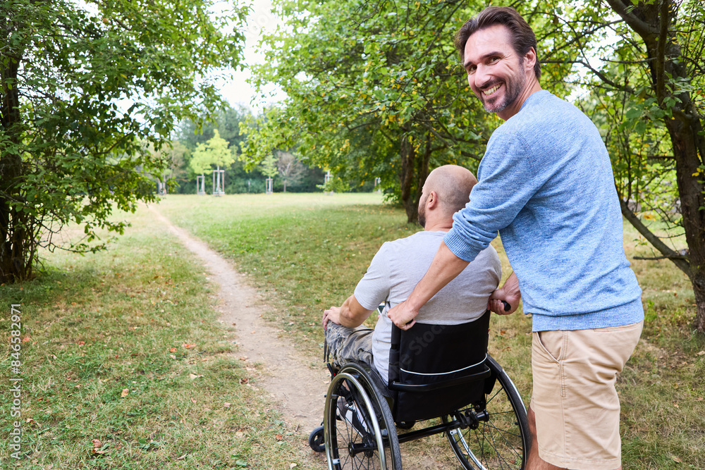 Friendly outing: Person with wheelchair enjoys a park walk with ...