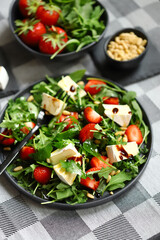 Wall Mural - Summer salad with strawberries, arugula, Camembert cheese and pine nuts.