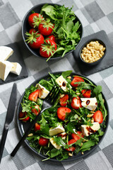 Wall Mural - Summer salad with strawberries, arugula, Camembert cheese and pine nuts.