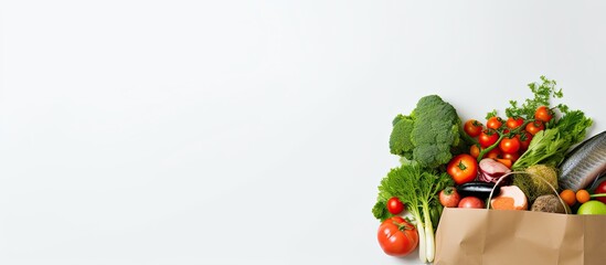 Poster - Paper bag filled with healthy food items like fish, vegetables, and fruits on a white background, creating a colorful copy space image.