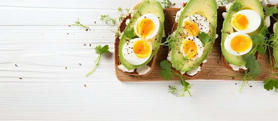 Leinwandbilder - Avocado toast with hard-boiled eggs on a white background, perfect for a healthy breakfast, with copy space image.