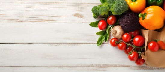Poster - Vegetables and fruits in a paper bag on a white wooden background with copy space image.