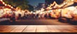 © vxnaghiyev - Wooden tabletop with no objects on it, blurred night market in the background, and selective focus, ideal for showcasing products with copy space image.