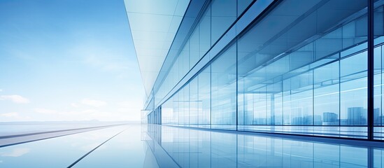 Poster - Glass building reflecting blue sky with a structural glass wall and an abstract modern architecture fragment, creating a contemporary architectural background with copy space image.