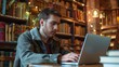© Thipphaphone - Young Caucasian Male Student Engaged in E Learning With Laptop in Vintage Library Setting