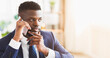 © Prostock-studio - Young african entrepreneur having pleasant conversation with business partner by phone, office interior, copy space