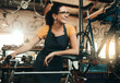 © Reese Coop/peopleimages.com - Workshop, woman and bicycle repair shop with mechanic, technician or maintenance with apron. Happy, service smile and business owner with startup, pride or bike for fixing with entrepreneur in garage
