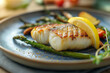 © Damian - plate of baked cod with a side of roasted asparagus