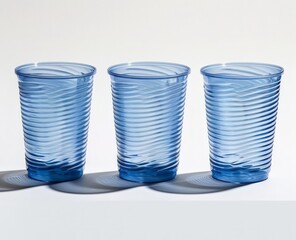 Three Blue Glasses on a White Table