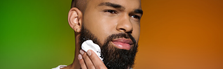 Wall Mural - African american attractive man using shaving cream.