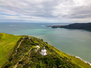 Wall Mural - aerial view of manukau heads lighthouse with backdrop of channel and coastline auckland new zealand.
