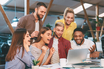 Poster - Lucky corporate team. Designers celebrate successful project realization, looking at laptop
