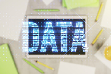 Poster - Creative Data word hologram and modern digital tablet on background, big data and blockchain concept. Multiexposure