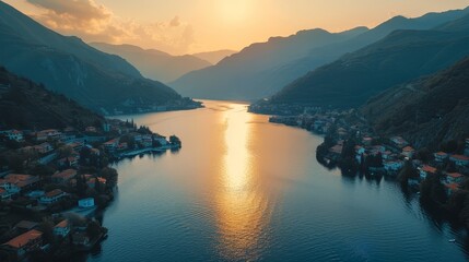 Breathtaking aerial view of a serene mountain lake at sunset,with the picturesque villages along the shore reflecting in the calm waters.