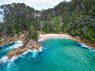 Wall Mural - aerial view of secluded pokohino beach, coromandel, new zealand. turquoise blue water in remote cove
