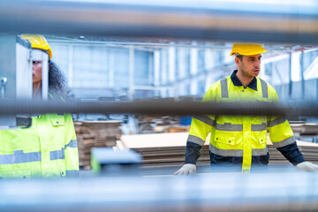 male and female technician engineers checking the process on Heavy machine. mechanical engineering team production. Industry manufacturing. Worker holding tablet and folde. High technology production.