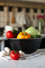 Canvas Print - Metal colander with different wet vegetables on white textured table, closeup