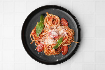 Wall Mural - Tasty pasta with tomato sauce, cheese and basil on white tiled table, top view