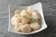 © New Africa - Fresh raw scallops and thyme in bowl on grey table