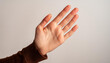 © Giuseppe Cammino - Detailed close-up of an open hand with palm lines visible against a light background