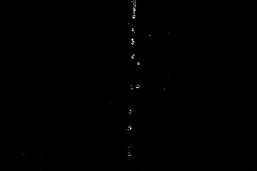 Poster - A black and white photo of water pouring from a faucet. Suitable for various design projects.