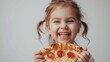 © Pavel Kachanau - A young girl holding a slice of pepperoni pizza, smiling and laughing