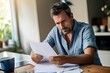 © neirfy - Worried man reading documents.
