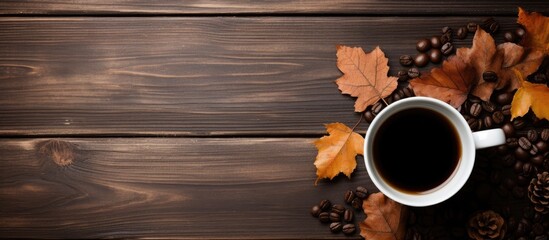 Fototapete - Coffee cup surrounded by fall leaves, pinecones, and acorns on a rustic wooden table. with copy space image. Place for adding text or design