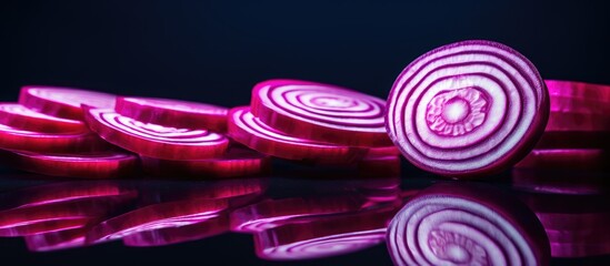 Canvas Print - Sliced red onions arranged on a black surface with a dark background, showcasing vibrant red rings of the onion bulb. with copy space image. Place for adding text or design