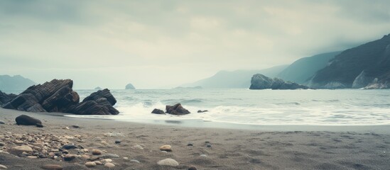 Poster - Boulders and stones line the shoreline of a vast ocean in a stunning seascape view. with copy space image. Place for adding text or design