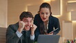 © stockbusters - Excited business team celebrating work success looking laptop at buro closeup