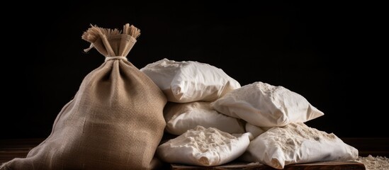Leinwandbilder - Bag of flour and loose flour spread on a wooden table, essential for baking and cooking. with copy space image. Place for adding text or design